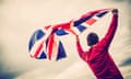 Man waving a Union flag against an open sky