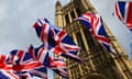 Union Jack flags fluttering outside the Houses of Parliament, London, UK.