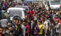 Palestinians in Gaza wait in long queues to buy bread on Sunday.