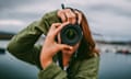 Young woman using DSLR camera<br>A young woman using a DSLR camera