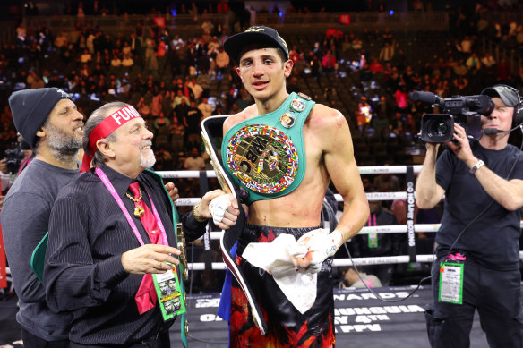 Sebastian Fundora poses with his title belts after defeating Tim Tszyu.