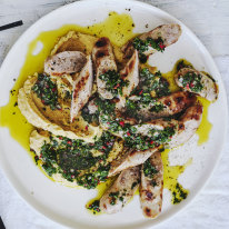 Grilled sausages on a bed of chickpea mash.