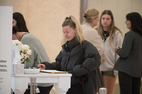 Shoppers sign the condolence book