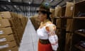 A person stands next to boxes with electoral kits ahead of the referendum, on 10 April in Quito, Ecuador. 