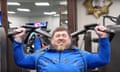 Ramzan Kadyrov using a shoulder press in a gym. His face is showing the strain from weightlifting