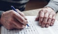 Older person playing Sudoku or similar puzzle game