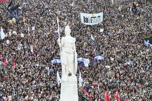 Demonstrators gather outside the Casa Rosada presidential palace during a march demanding more funding for public universities and to protest against austerity measures proposed by President Javier Milei, in Buenos Aires, Argentina, Tuesday, April 23, 2024. (AP Photo/Rodrigo Abd)