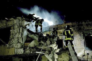 In this photo provided by the Mayor of Odesa Hennadii Trukhanov in Telegram, firefighters work on the site of a burning building after a Russian drone attack in Odesa, Ukraine, Tuesday, April 23, 2024.