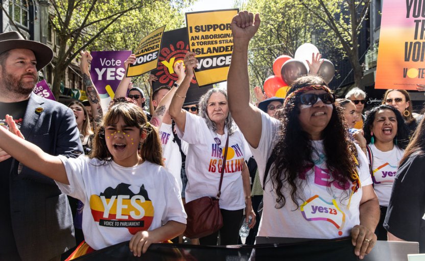 Supporters of the “Yes” campaign in Melbourne, Sunday, September 17, 2023, wearing "yes" T-shirts and raising their fists