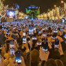 Revellers at the Arc de Triomphe in Paris on New Year’s Eve are too busy filming to celebrate the arrival of the new year.