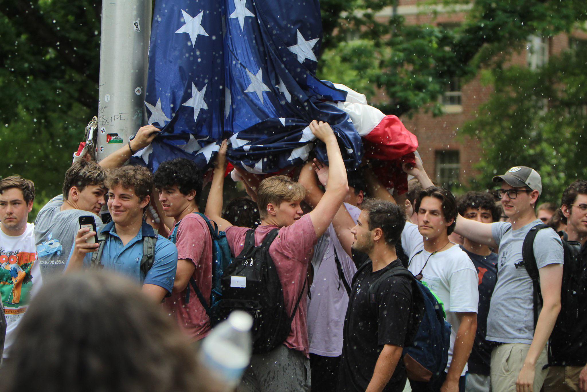 r/pics - UNC Chapel Hill students surround the American flag to protect it from being removed. 