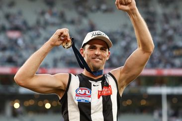 Scott Pendlebury celebrates his second premiership medal.