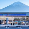 A Lawson convenience store with Mount Fuji in the background. 