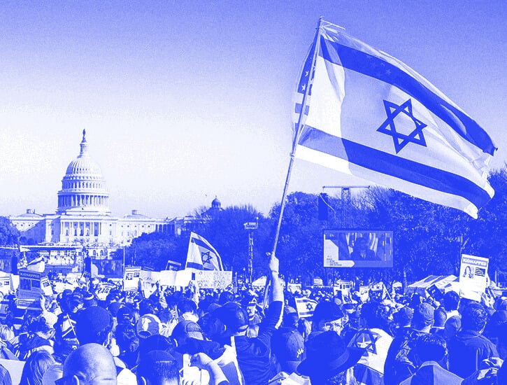 At a large pro-Israel protest on Capitol Hill, an Israel flag flies above the crowd. In the distance, the Capitol building.