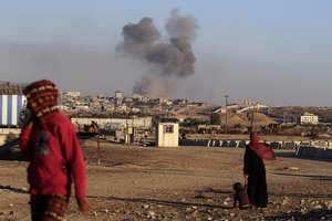 Smoke rises following an Israeli airstrike on buildings near the separating wall between Egypt and Rafah, southern Gaza Strip, Tuesday, May 7, 2024.