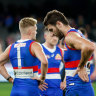 Marcus Bontempelli and Adam Treloar look dejected after the Bulldogs’ shock loss to the Hawks.