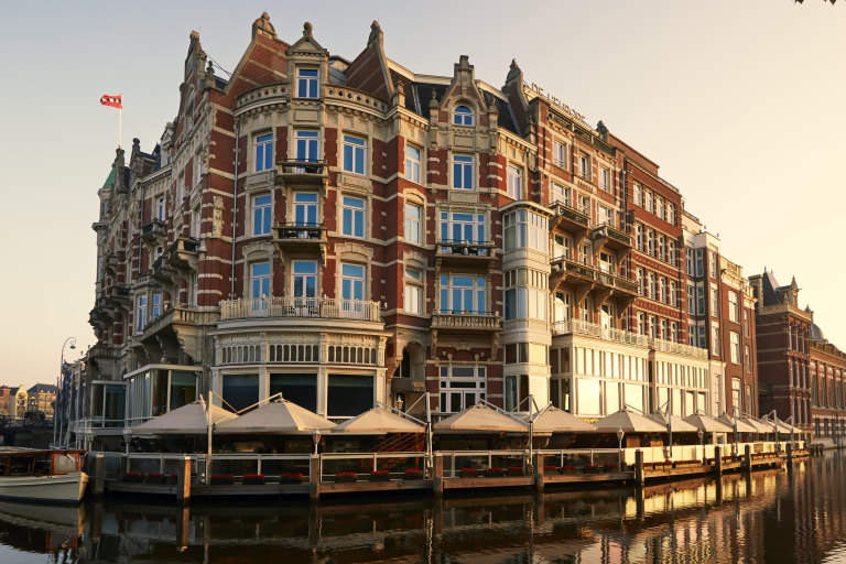 Board a classic wooden boat from the hotel’s riverside terrace for a private guided canal tour to the Van Gogh Museum.