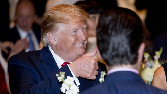 Donald Trump enjoys dinner with guests at Mar-a-Lago in 2019.