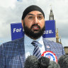 Leader of the Workers Party of Britain George Galloway (right) looks on as former England cricketer Monty Panesar (centre) addresses fellow party candidates in Parliament Square.