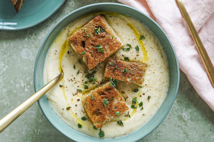 Creamy cauliflower and potato soup topped with mini cheese toastie bites.