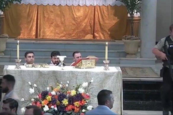 Clergy react during the incident in the Louisiana church.