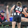 Collingwood defender Nathan Murphy consoles Angus Brayshaw as he leaves the ground after being concussed in the qualifying final. Both players are now retired due to medical advice following a series of concussions