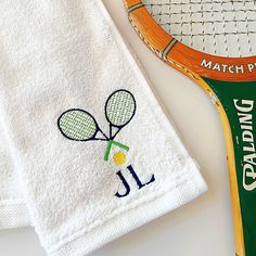 two tennis racquets are sitting next to a towel on top of a table