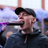 A fan holds a smoke flare in his mouth outside the stadium prior to the Premier League match between Aston Villa and Liverpool FC at Villa Park in Birmingham, England.