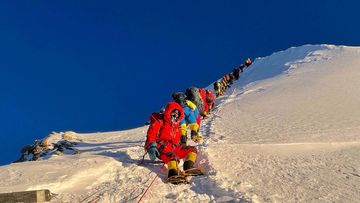 	Mountaineers as they climb during their ascend to summit Mount Everest in May 2021.