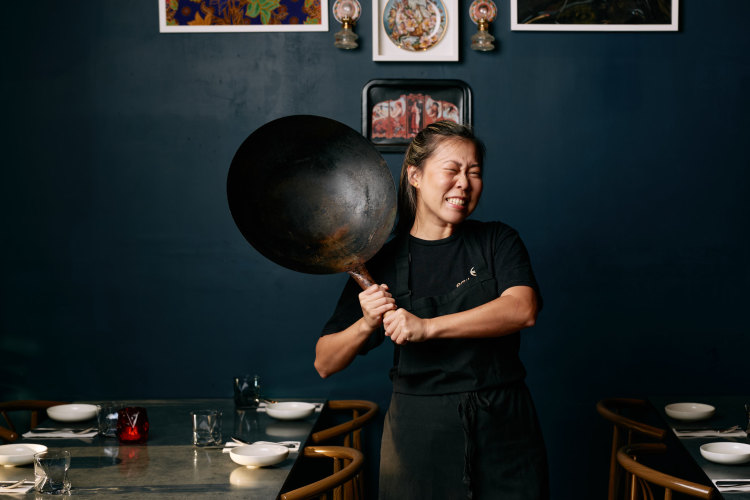 Emily Yeoh with a larger version of the $15 wok she recommends from Yuen’s in Brisbane, or a similar Asian grocery store.