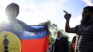 Demonstrators hold Kanak and Socialist National Liberation Front (FLNKS) flags during a gathering in Paris.