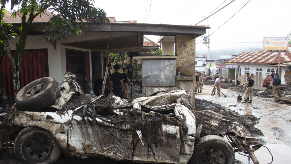 People clean up after a flash flood in Agam, West Sumatra, Indonesia.