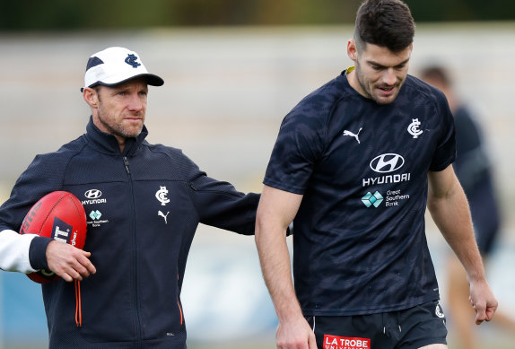 Carlton’s high-performance boss Andrewe Russell with midfielder George Hewett (right).