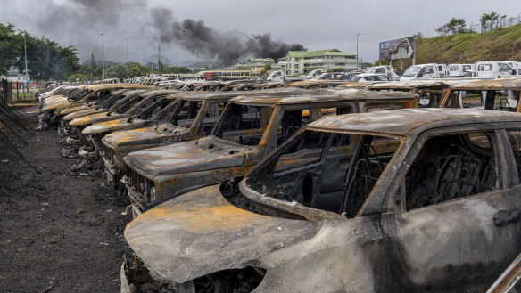 Burnt cars are lined up after unrest that erupted following protests over voting reforms in Noumea, New Caledonia.