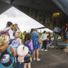 Australian and other tourists board an Australian Airforce Hercules as they prepare to depart from Magenta Airport in Noumea, New Caledonia on Tuesday.