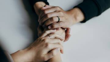 A woman's hands holding another woman's hands. Picture by Priscilla Du Prezze, Unsplash. 