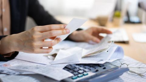 Calculator and bills on a table