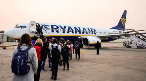 Passengers boarding a Ryanair plane