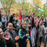 Protesting students rally outside the Arts West building at University of Melbourne on Friday afternoon.