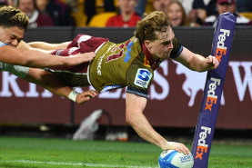 Tim Ryan of the Reds scores one of his three tries.