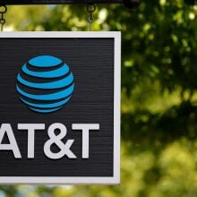  A sign is posted in front of an AT&T retail store.