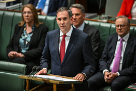 Treasurer Jim Chalmers reading his budget speech.