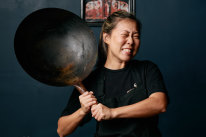 Emily Yeoh with a larger version of the $15 wok she recommends from Yuen’s in Brisbane, or a similar Asian grocery store.