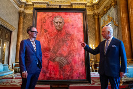 Artist Jonathan Yeo and King Charles III stand in front of the King’s portrait as it is unveiled in the blue drawing room at Buckingham Palace in London, England.