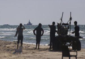 A ship belonging to the Open Arms aid group approaches the shores of Gaza towing a barge with 200 tons of humanitarian aid on Friday, March 15, 2024. The ship set sail Tuesday from Cyprus to inaugurate a sea route to get desperately needed aid into the war-wracked enclave, which is suffering a humanitarian crisis five months into the Israel-Hamas war.