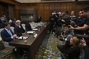 Journalists take images of Israel legal team, with Yaron Wax, Malcolm Shaw and Avigail Frisch Ben Avraham, from left, before Judges enter the International Court of Justice, or World Court, in The Hague, Netherlands, Friday, May 24, 2024, where the top United Nations court ruled on an urgent plea by South Africa for judges to order Israel to halt its military operations in Gaza and withdraw from the enclave.