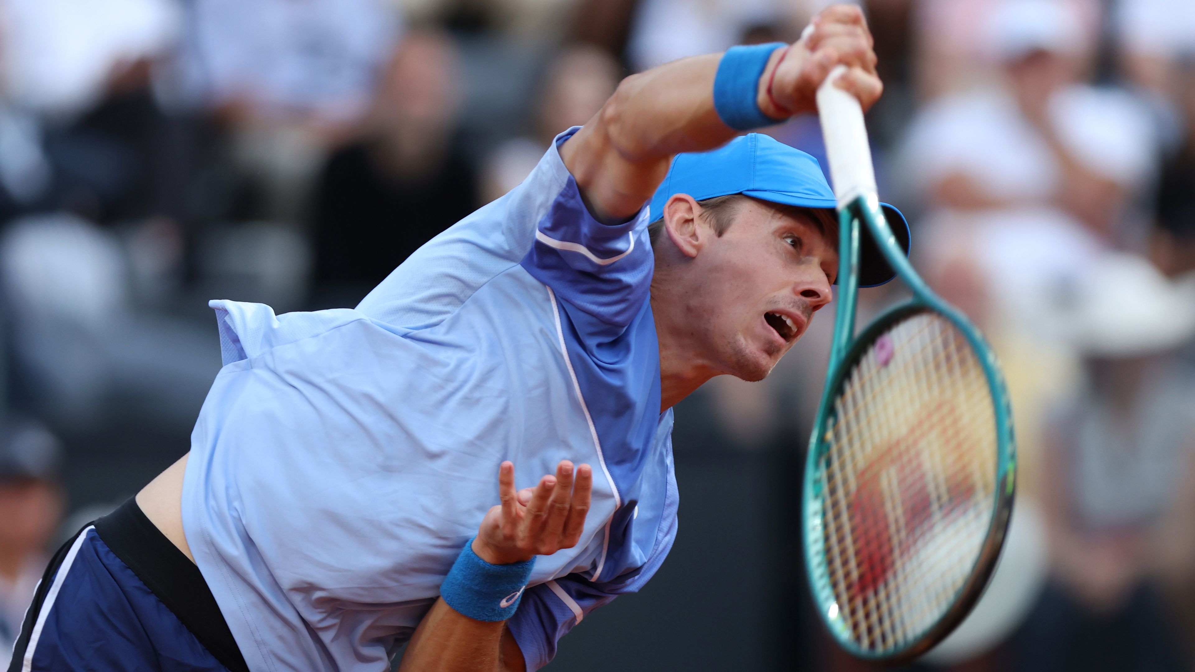 Alex de Minaur of Australia serves against Stefanos Tsitsipas of Greece in Rome.