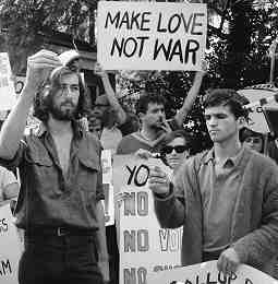 Anti-Vietnam War protest, April 27, 1968. Photo shows draft registration cards being burnt, one sign reads "Make Love Not War!"