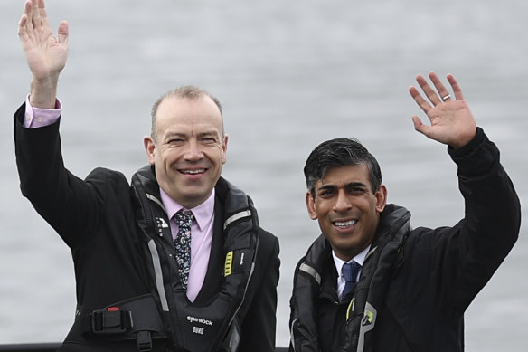 Britain’s Prime Minister and Conservative Party leader Rishi Sunak, right, and Britain’s Northern Ireland Secretary Chris Heaton-Harris wait on board an Artemis Technologies boat before a tour during a visit to the maritime technology centre at a dockyard in Belfast, on Friday.