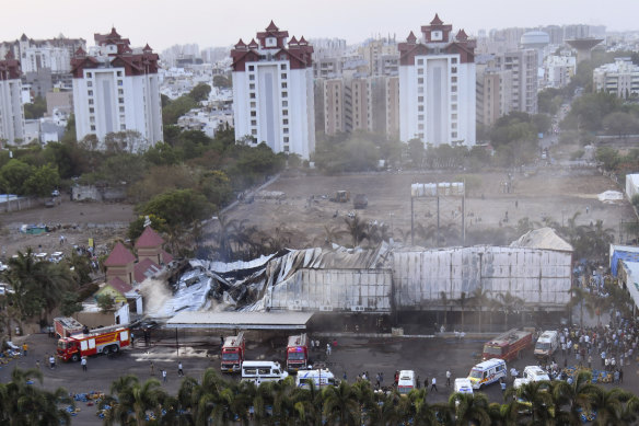 Firefighters douse a fire that broke out in a fun park, in Rajkot in the Indian state of Gujarat on Saturday.